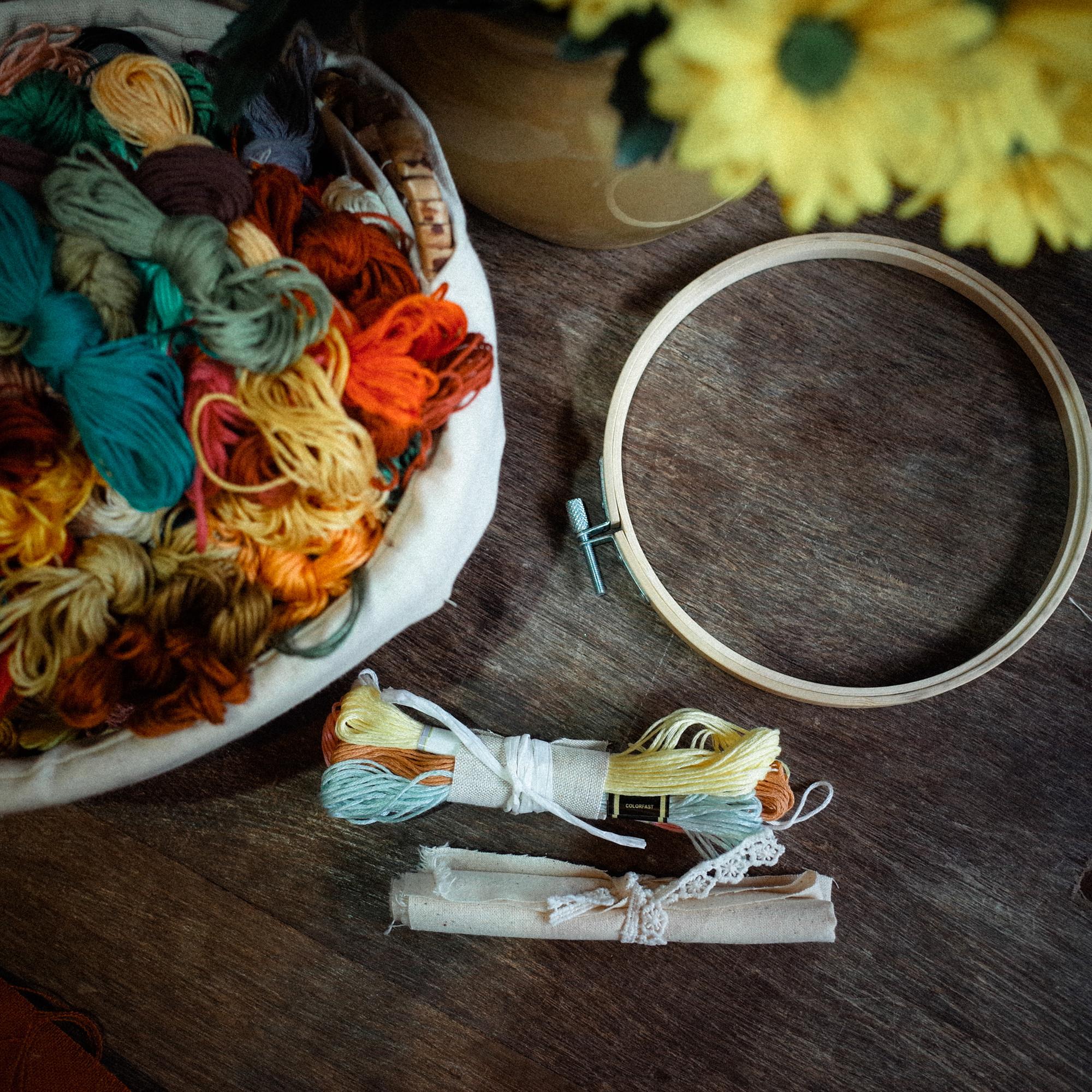 Artisan arranging threads on wooden tray