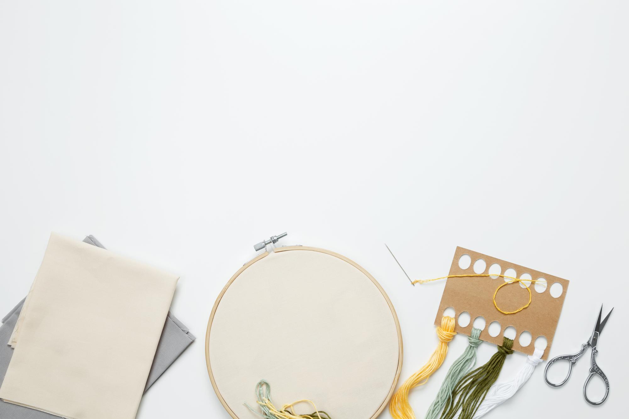 Workshop table with finished embroidery pieces